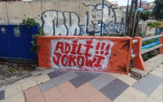 Tulisan vandalisme bertuliskan "Adili Jokowi" muncul di Jalan Prapen Kota Surabaya. (Istimewa)